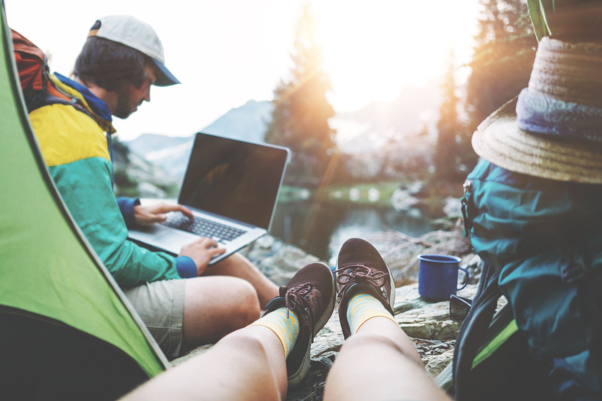 Couple of backpackers hiking and camping in wild